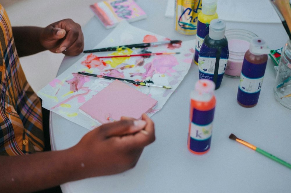 Small hands painting with bright colors